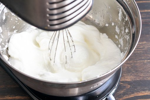 Egg whites that have been beaten in a stand mixer until they form stiff peaks